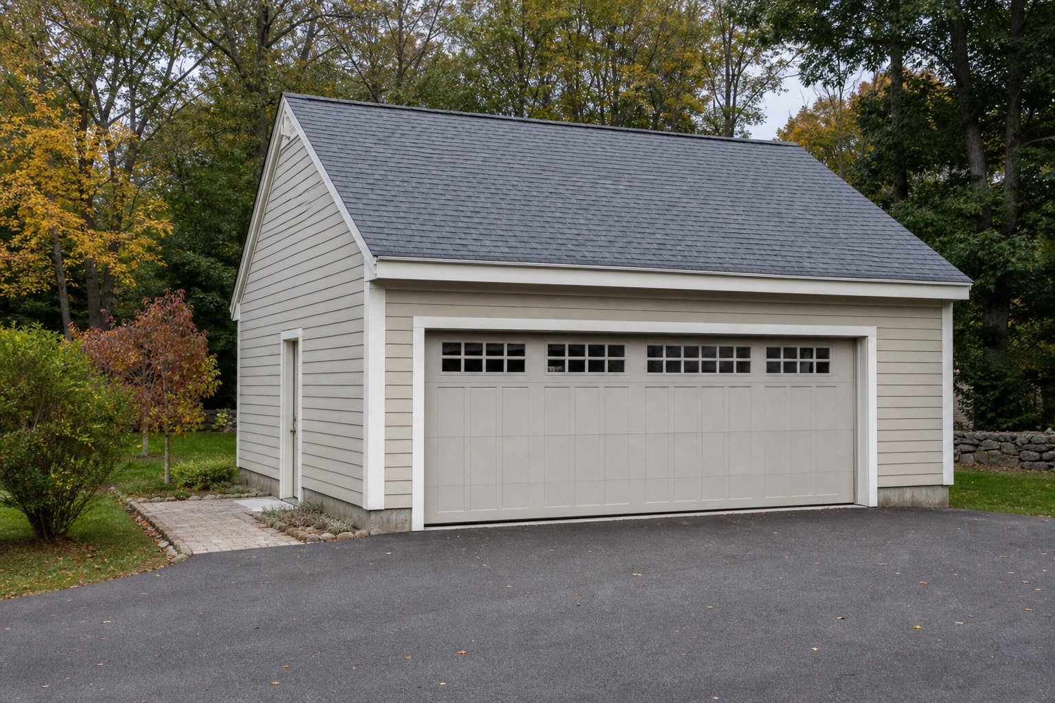 Suburban garage door in Carlisle, MA with a clean driveway and autumn light